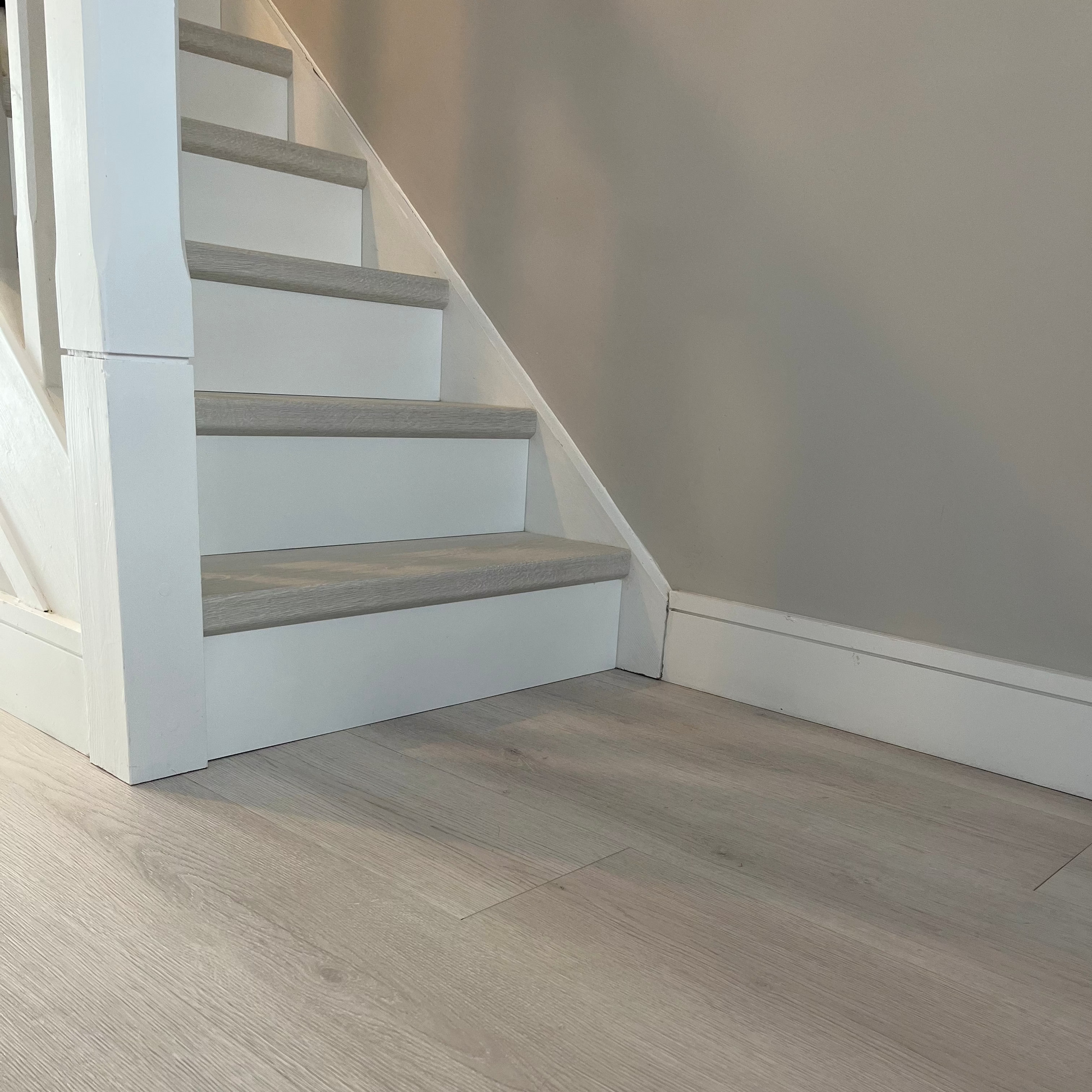 Wooden floor with a staircase in the background